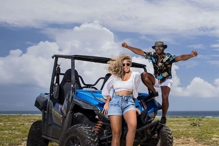 a man and a woman riding on the back of a truck
